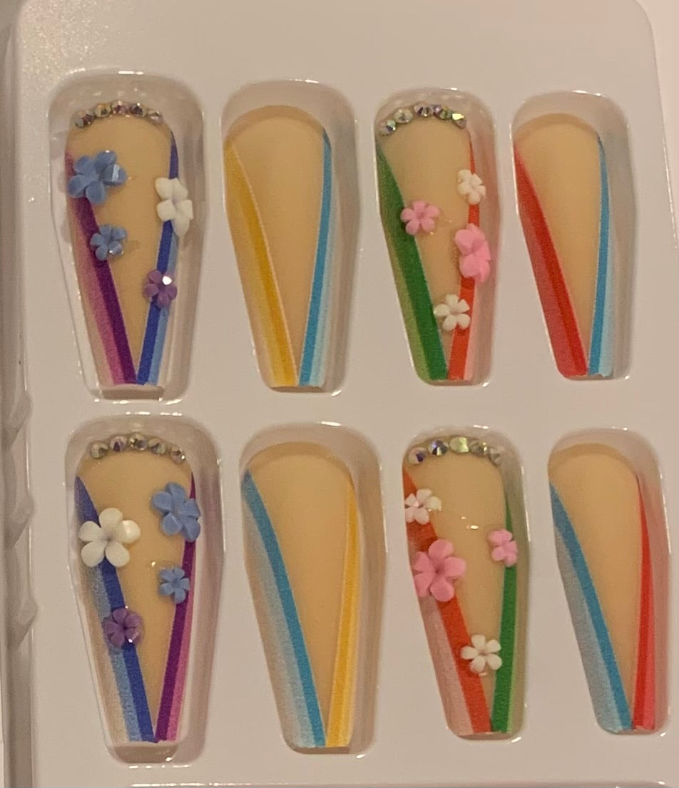 Set of decorative false nails with flowers and colorful stripes.