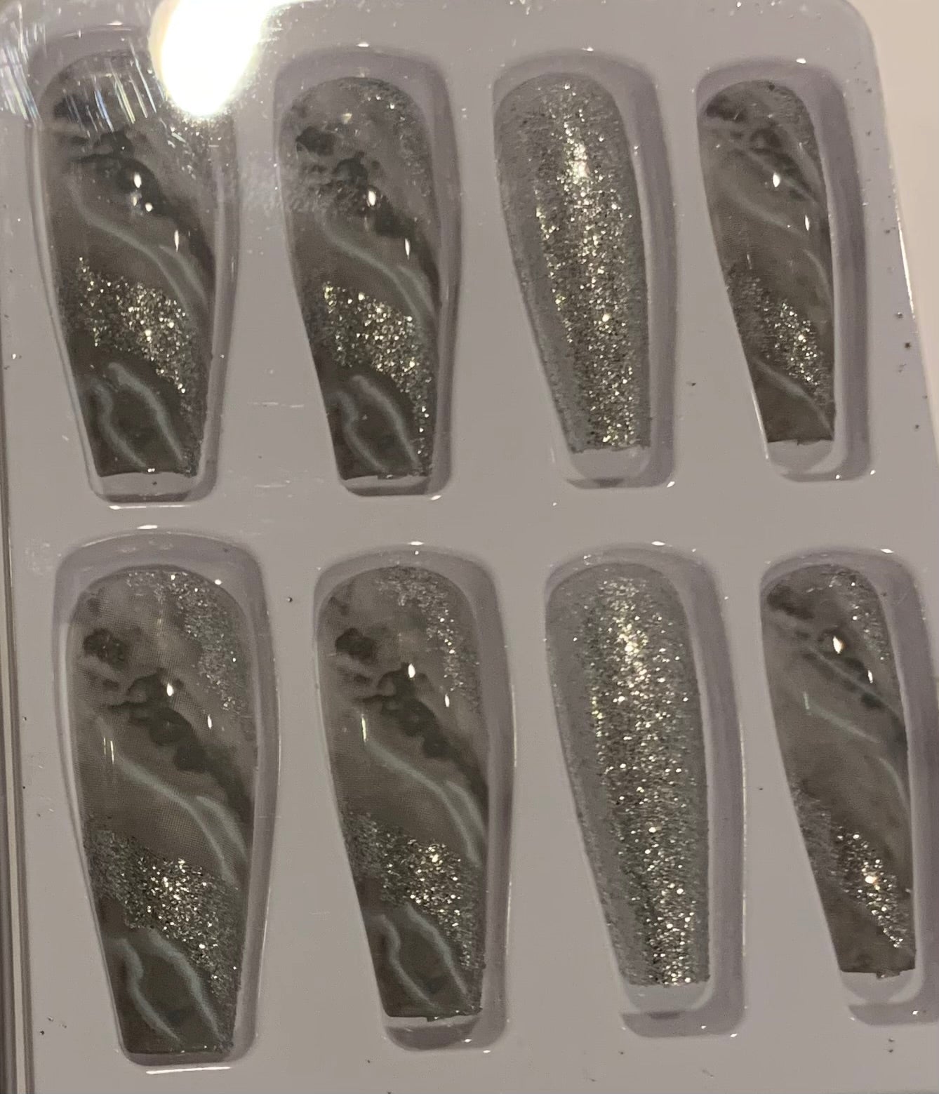 Set of shimmery silver and gray nails.