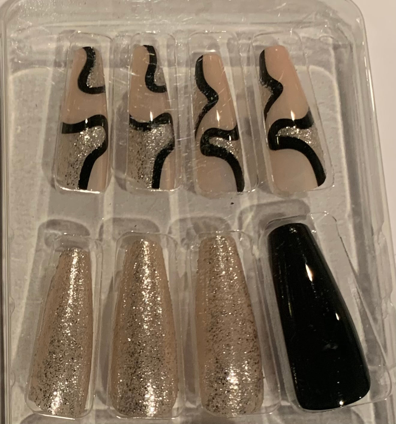 Set of false nails with black and gold tiger-print  designs.