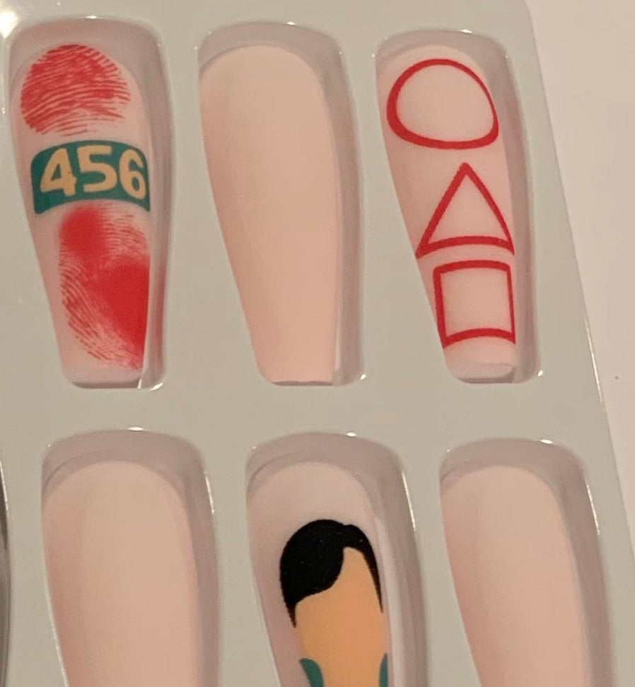 Set of nail art designs with shapes, numbers and a male figure. 
